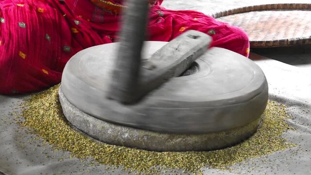 making dal from whole pulses using stone quern or hand chakki. 