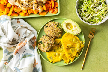 Enjoy a vibrant breakfast featuring scrambled eggs with rhubarb, fluffy quinoa pancakes, creamy avocado drizzled with olive oil, roasted vegetables, and a refreshing fresh salad