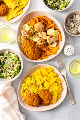 Enjoy a flavorful meal featuring rice topped with rhubarb fried eggs, baked sweet potato, and colorful veggies. Fresh salad and crispy meat fritters complete this delightful dish