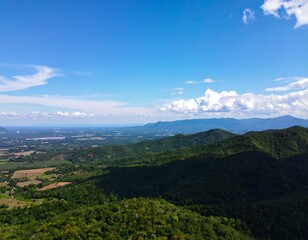 Panoramic view of lush green mountains and valleys under a clear blue sky