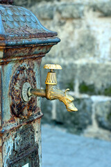 Drinking fountain on street of Alghero, Sardegna, Italy. Close-up of a decorative old faucet from a drinking fountain