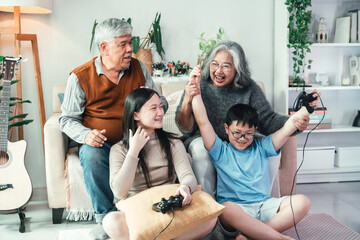 Children Playing Video Game with Grandparents in Cozy Living Room Highlighting Intergenerational Bonding, Family Interaction, Teamwork, and Togetherness