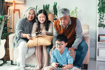 Children Playing Video Game with Grandparents in Cozy Living Room Highlighting Intergenerational Bonding, Family Interaction, Teamwork, and Togetherness