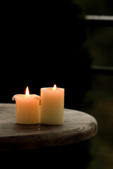 Autumn Pumpkins with Candles – Halloween Decoration. Cozy Halloween scene with autumn pumpkins, candles, and festive miniatures in a basket. Rustic wooden table and soft mysterious daylight create sea