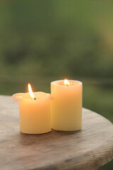 Autumn Pumpkins with Candles – Halloween Decoration. Cozy Halloween scene with autumn pumpkins, candles, and festive miniatures in a basket. Rustic wooden table and soft mysterious daylight create sea