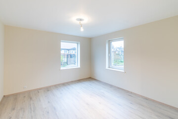 Modern New Construction Empty Room With Wooden Flooring and Large Windows. Home Interior