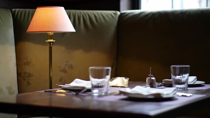 Elegant restaurant booth seating with table and place setting scene