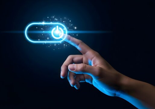 A hand pressing a glowing blue power button on a dark background with sparkling light effects around it
