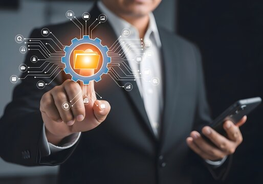 A man in a suit touching a digital folder icon with a gear surrounded by connected icons and lines