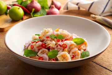Spicy Lemongrass Salad with Shrimps in white plate.Thai food.