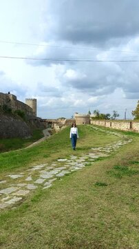 Female traveler walking near Zindan Gate and Despot Tower
in Belgrade Fortress. Concepts of iconic landmark, Balkan sightseeing, cultural exploration, city heritage and architectural appreciation