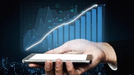 A hand holds a smartphone displaying a financial growth chart, illustrating advanced data...