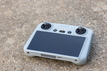 Drone remote controller lying on ground in urban setting