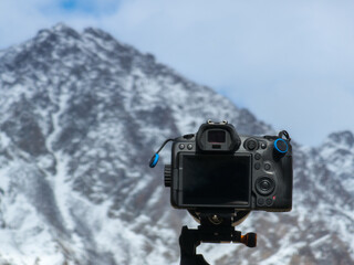 Camera capturing serene mountains during daytime outdoors