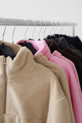 Fleece sweaters on hangers. Fashion, online stores, seasonal clothing collections.