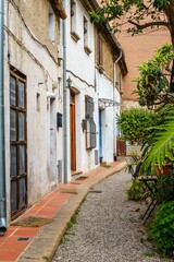 Quiet residential street lined with charming architecture and greenery. Badalona, Spain