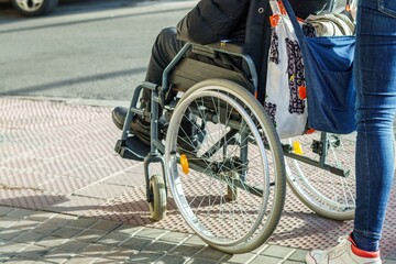 Naklejka premium Elderly disabled patient walking slowly with a walker in the street. Elderly disabled adults feel painful and suffer from back pain. Medical therapy insurance concept