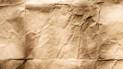 Textured brown paper surface with wrinkles and creases for background use.