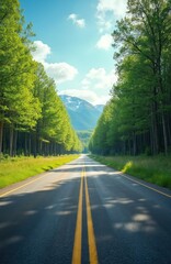 Obraz premium Straight road stretches through vibrant green forest on sunny day. Tall trees line asphalt path. Distant snow capped mountains rise under bright blue sky with fluffy white clouds. Perfect scene for
