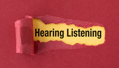A torn piece of paper with the words Hearing Listening" written on it