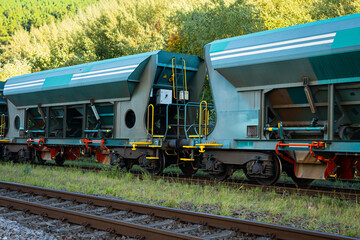 Obraz premium Modern freight hopper wagons on railway track side view