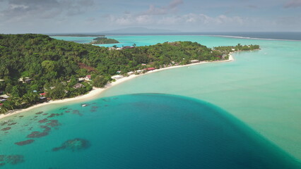 Stunning drone aerial tropical island paradise with turquoise water, lush vegetation, white sandy...