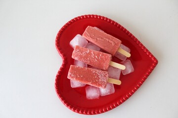 Fresh vegan popsicles with fruit served on a hearty plate to eat after making love
