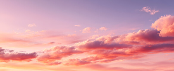 Obraz premium Dreamy sky filled with soft pink clouds during a vibrant sunset