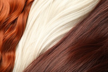 Naklejka premium Strands of different beautiful hair as background, top view