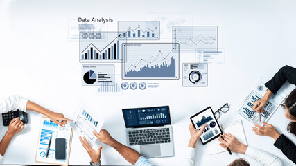 Professionals engage in a collaborative data analysis session, utilizing charts, graphs, and digital tools to track performance metrics and drive business insights. Trope