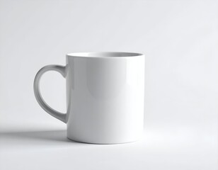 A plain white ceramic mug with a curved handle against a white backdrop