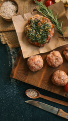 Delicious Meatballs and Burger with Herbs on Wooden Board