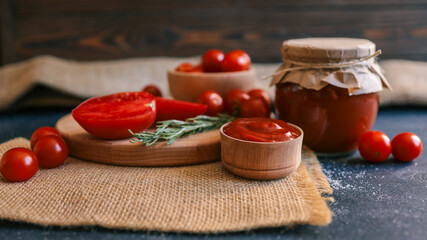 Fresh tomato ingredients with ketchup in a rustic setting