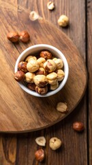 Hazelnuts in a bowl on a wooden board