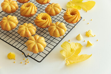Autumn-Themed Mini pumpkin Cakes with Seasonal Decorations on White Background