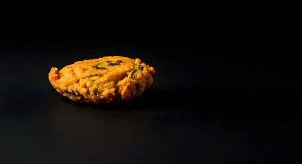 A minimalist shot of a single piece of pakora