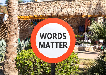 Words matter symbol. Concept word Words matter on beautiful red and white road sign. Beautiful palm...