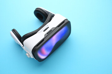 VR headset with glowing screen on blue background — virtual reality immersive technology concept