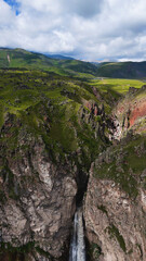 Flying over the Jily-Su Waterfall in the Caucasus in the summer
