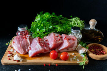 Raw Meat with Tomatoes Garlic and Parsley on Cutting Board