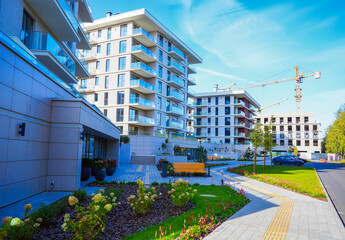 Hotel construction. Tower crane on building construction. Multi Storey Residential Buildings construction. Green courtyard at Condominium. Cityscape of residential area with modern apartment buildings
