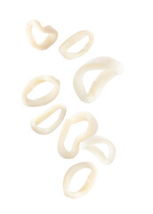 Obraz premium Fresh squid rings flying in air against white background