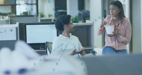 Woman entering office with takeout box and man swiveling exchanging business feedback at monitors - Powered by Adobe