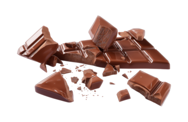 Pieces of dark chocolate falling close up on a white background