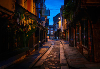 Fototapeta premium York city's historic alley at sunrise, featuring well-preserved landmark architecture and medieval timber-framed buildings, a popular tourist attraction and shopping area in Yorkshire, England.