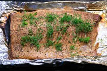 Smoked salmon with dill on a baking sheet, selective focus