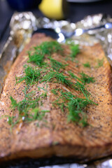Smoked salmon with dill on a baking sheet, selective focus