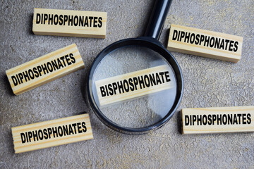 Bisphosphonate or diphosphonates on stacked wooden cubes on the table. Business and finance concept