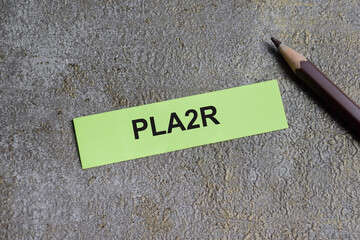 Concept of PLA2R - Phospholipase A2 Receptor write on sticky notes isolated on Wooden Table.