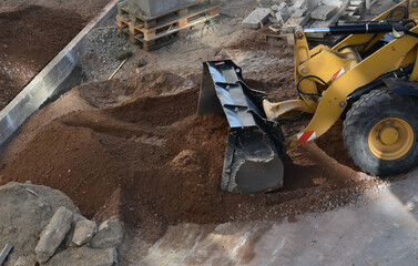 Excavator working on construction site moving soil